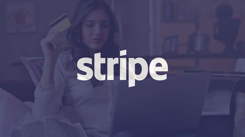 woman holding credit card using laptop with Stripe logo overlay